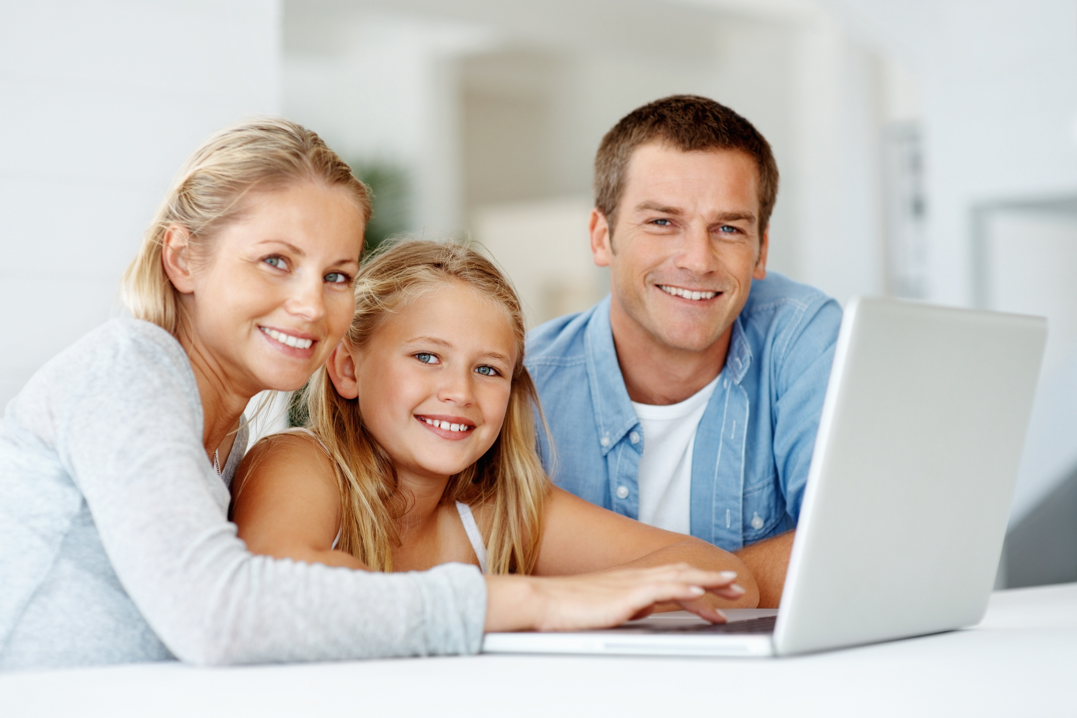 family looking at laptop